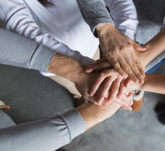 about us group picture with hands